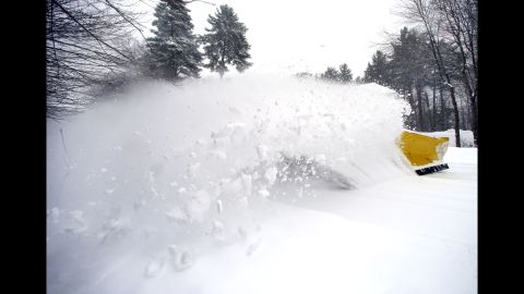 A wave of snow is kicked up as a truck clears a street in North Andover, Massachusetts, on February 5.