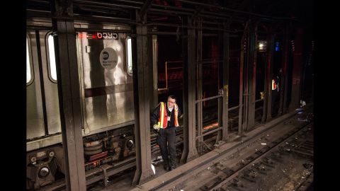 A New York City transit official checks the tracks at the Times Square subway station on February 5.