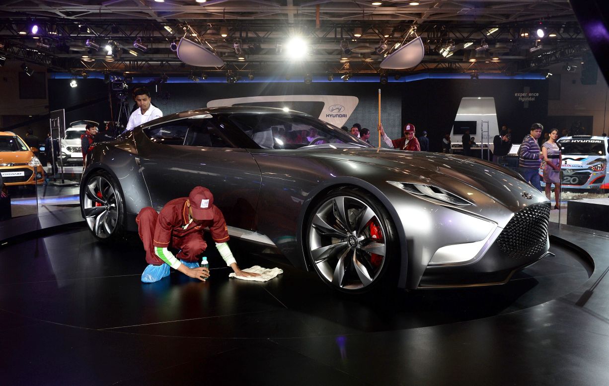 Hyundai's futuristic Venace concept model gets a polish on the podium in New Delhi. 