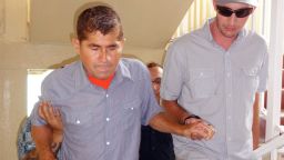 Pacific castaway Jose Salvador Alvarenga (L) is helped into a press conference in the Marshall Islands capital of Majuro on February 6, 2014
