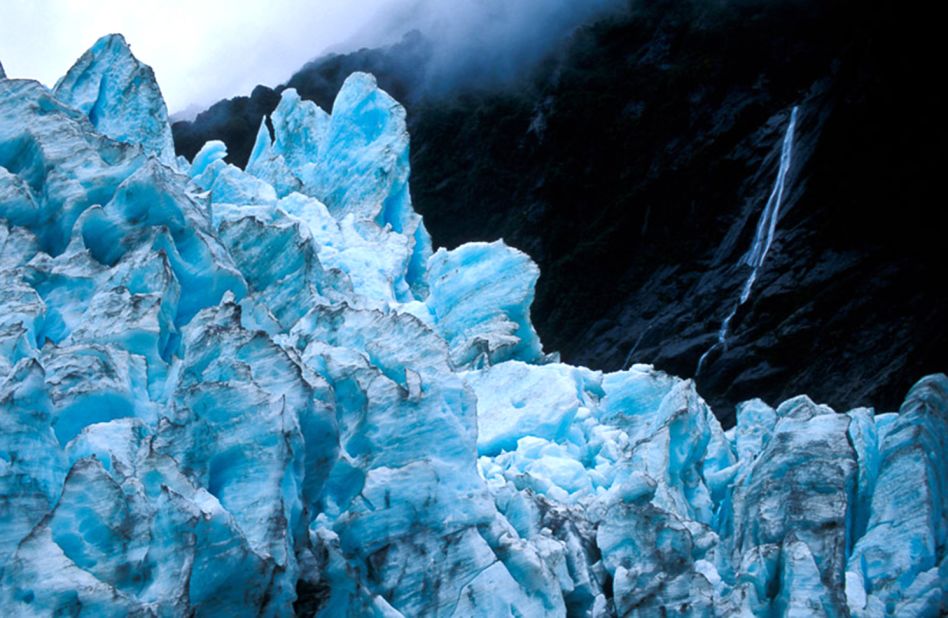 The 12-kilometer-long glacier descends from the Southern Alps through temperate rainforest to near sea level. 