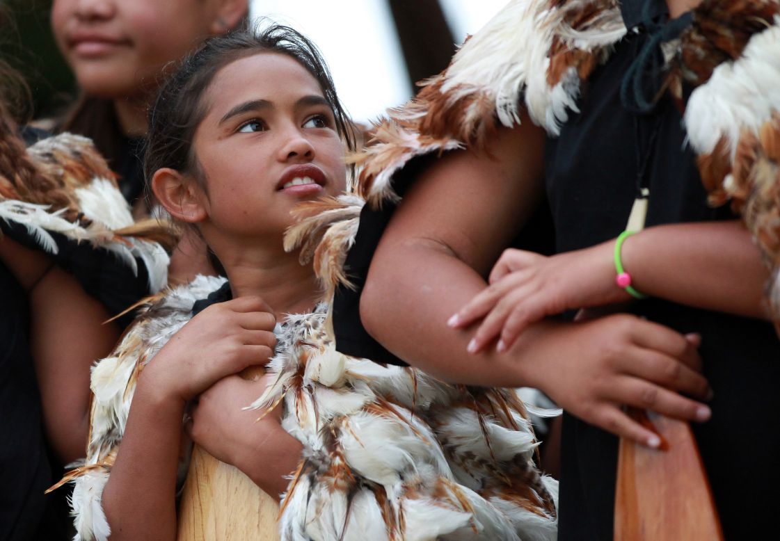 FEBRUARY 6 - PAIHIA, NEW ZEALAND: A young girl watches a Waka crew perform on the beach to celebrate Waitangi Day. The  national holiday celebrates the signing of the Treaty of Waitangi on February 6, 1840 by Maori chiefs and the British Crown, that granted the Maori people the rights of British subjects and ownership of their lands and other properties.