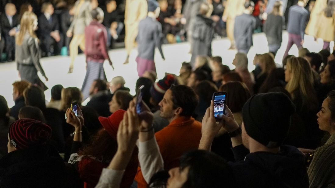 Instagram, and Twitter, and Facebook, oh my! The audience photographs the Richard Chai fashion show on February 6, 2014.