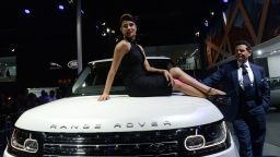 Indian Bollywood actress Priyanka Chopra (C) poses on the bonnet of a Range Rover "LWB AUTOBIOGRAPHY BLACK" after the launch ceremony at the 12th Auto Expo in Greater Noida on the outskirts of New Delhi on February 5, 2014 .AFP PHOTO/ SAJJAD HUSSAINSAJJAD HUSSAIN/AFP/Getty Images