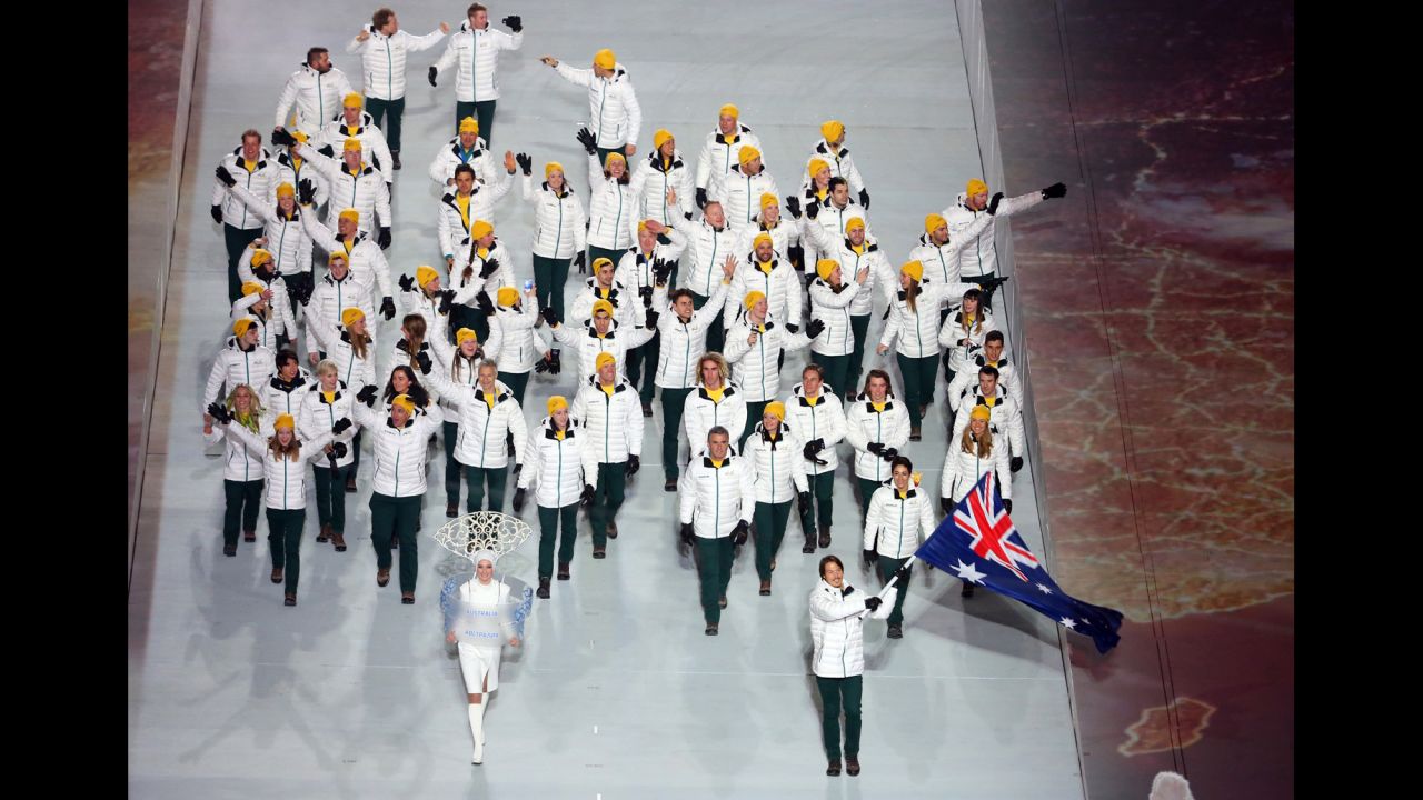 Snowboarder Alex Pullin of the Australian Olympic team carries his country's flag during the opening ceremony.