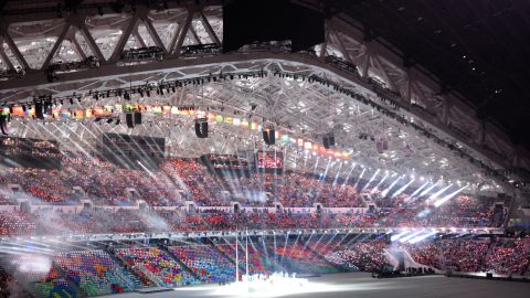 Performers take their places inside the packed stadium.
