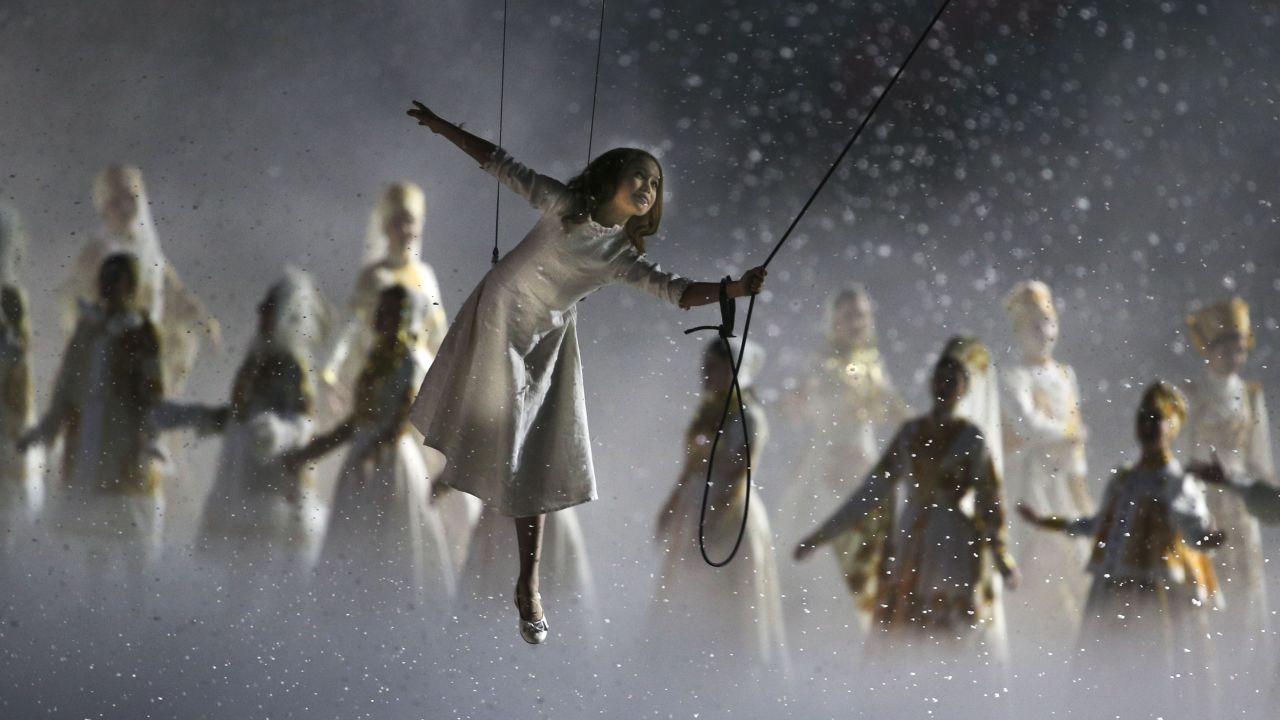 A girl takes a "magical kite ride through history" during the opening ceremony.