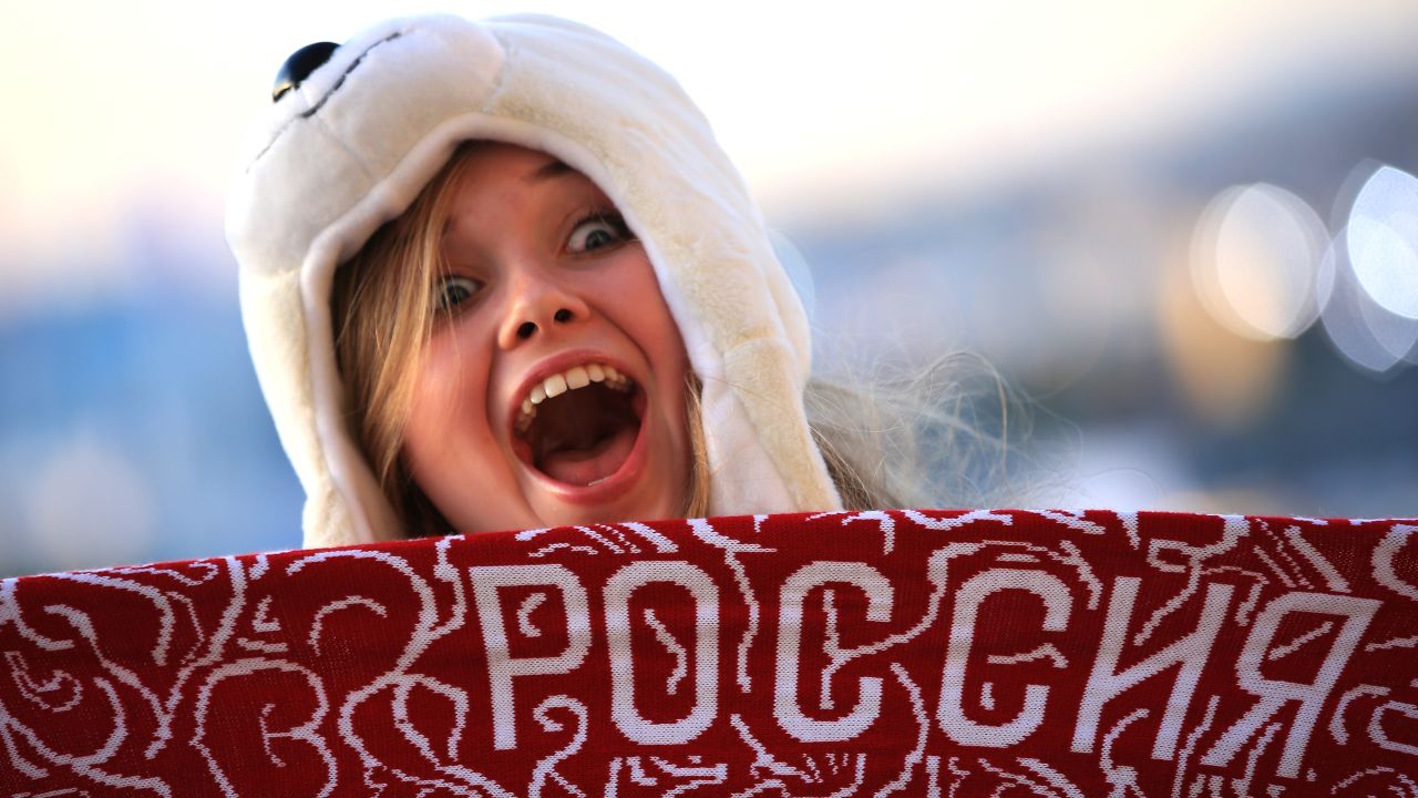 A spectator poses for a photo as she arrives for the opening ceremony.