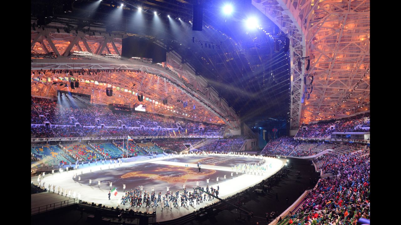 Members of Italy's delegation wave to the crowd.