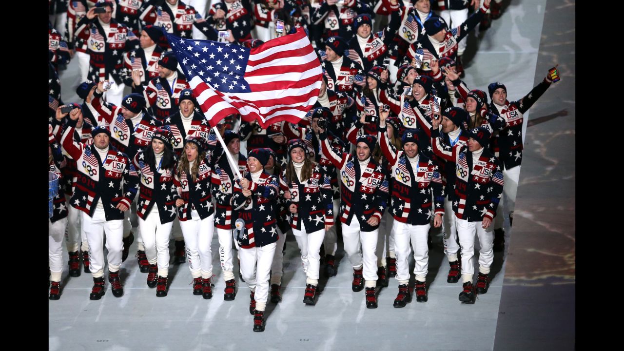 Skier Todd Lodwick carries the American flag during the opening ceremony.