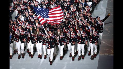 Skier Todd Lodwick carries the American flag during the opening ceremony.