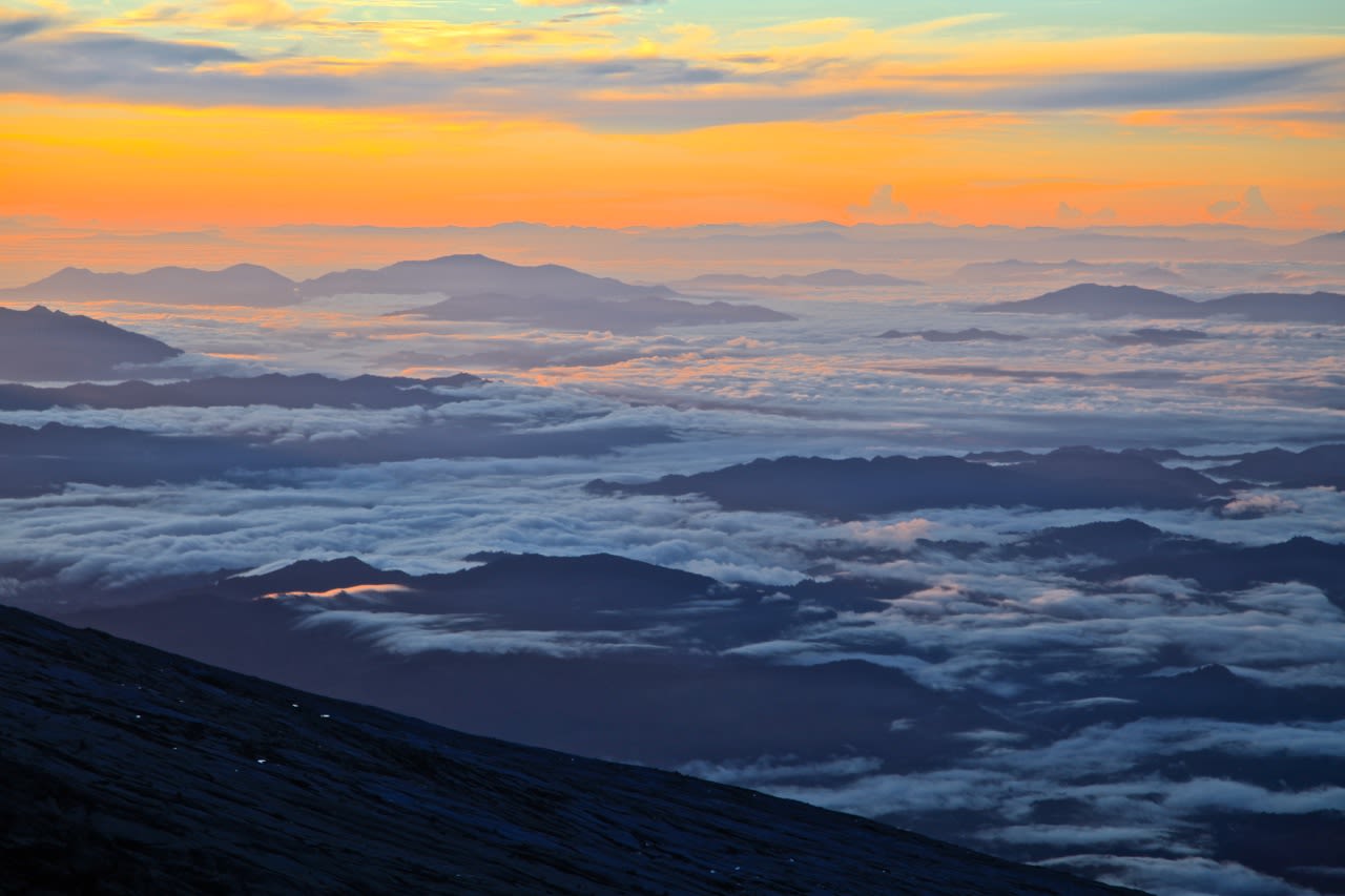 The sun rising over Malaysia's Sabah state, seen from the summit at Low's Peak on Mount Kinabalu. 
