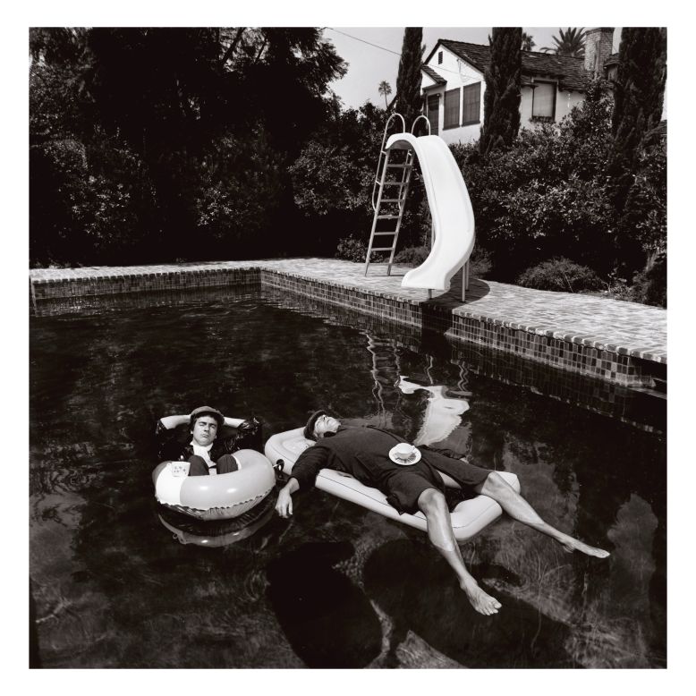 British actor-comedians Dudley Moore and Peter Cook were inseparable. In 1975 O'Neill photographed the pair wearing raincoats and floating in a swimming pool at the house of Keith Moon, the lead drummer for The Who.