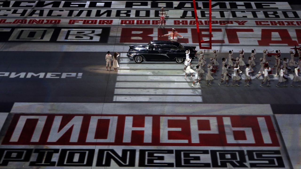Text is projected on the floor of the stadium.