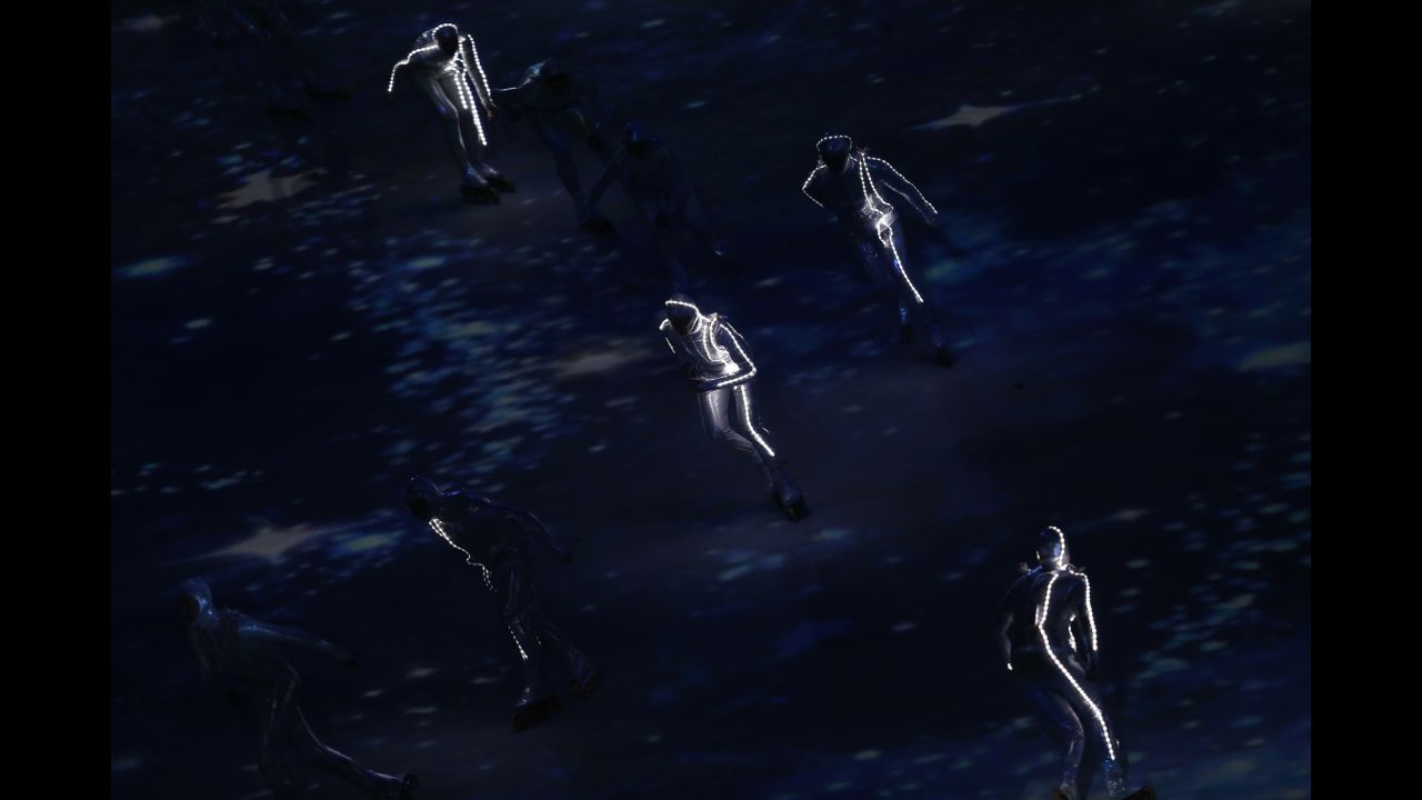 Performers skate around the stadium floor during the ceremony.