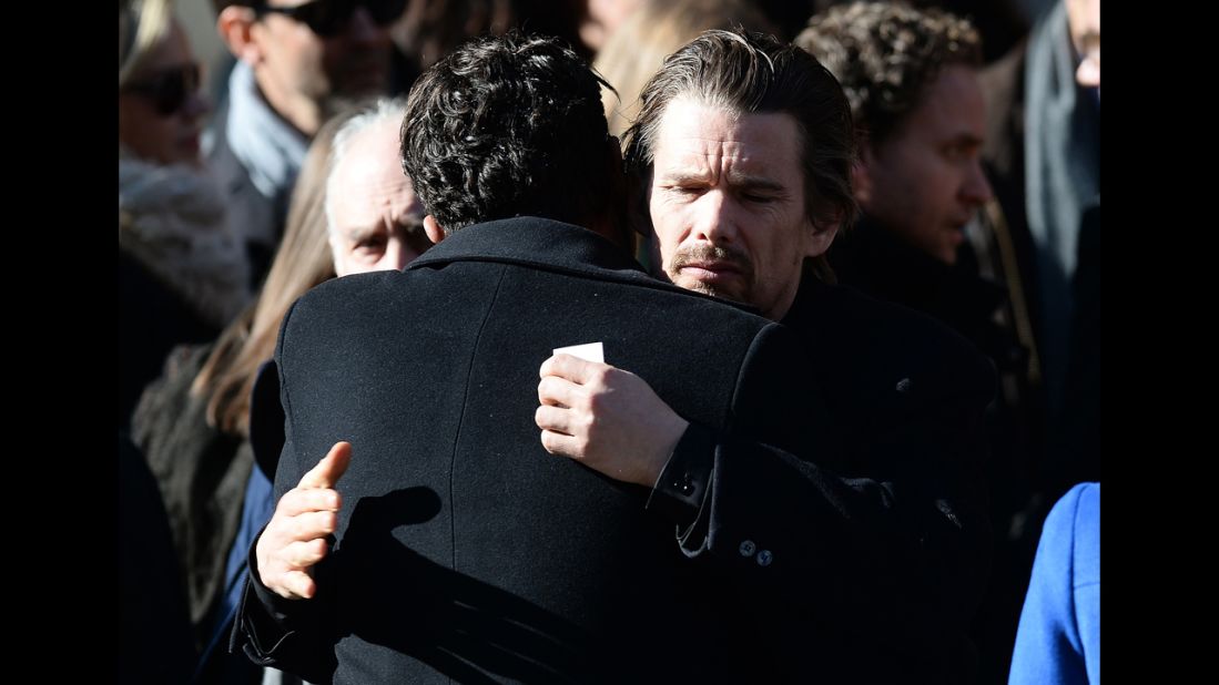 Actor Ethan Hawke hugs another mourner after the service. 