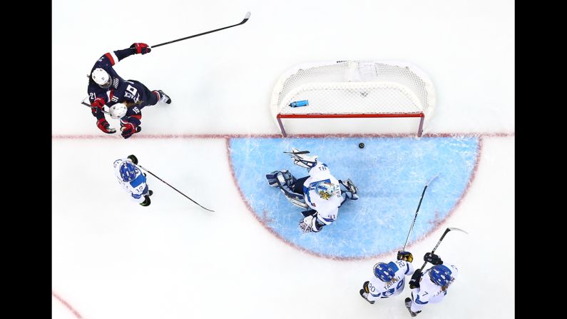 Two Americans celebrate February 8 after a goal against Finland during their women's ice hockey game.