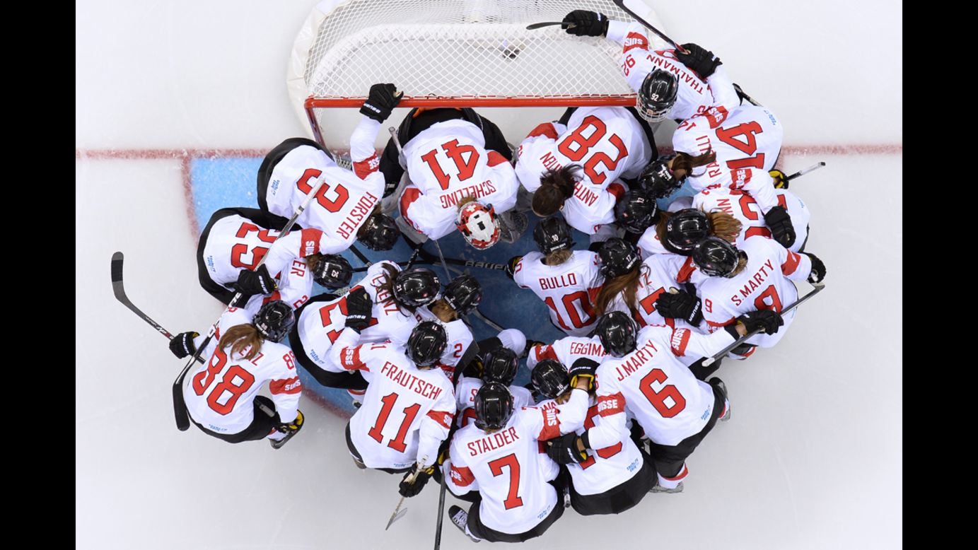 The women's hockey team of Switzerland huddles before the start of its Group A match against Canada.