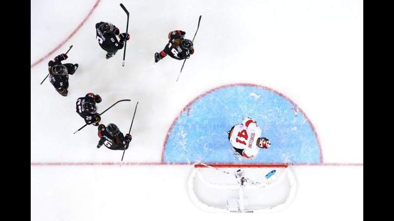 Canada's women's hockey team celebrates after scoring a goal against Switzerland during their preliminary round game February 8.