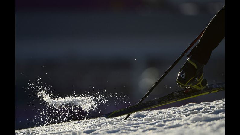 Snow flies on February 8 during the men's 10-kilometer biathlon sprint.