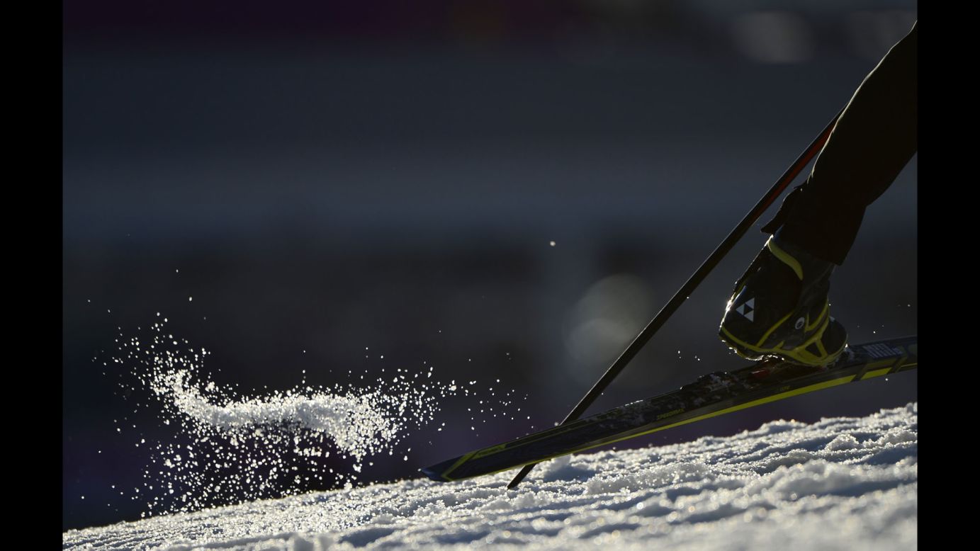 Snow flies on February 8 during the men's 10-kilometer biathlon sprint.