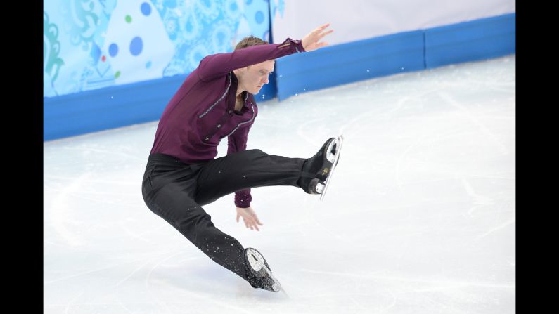 Jeremy Abbott of the United States falls as he performs in the team figure skating event.