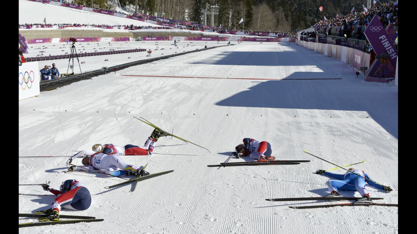 Norway's Marit Bjoergen, Sweden's Charlotte Kalla, Norway's Therese Johaug, Norway's Heidi Weng and Finland's Aino-Kaisa Saarinen fall to the ground after the women's skiathlon on February 8.