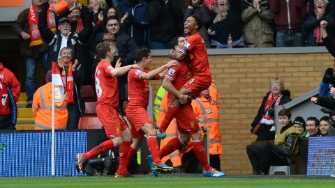 Raheem Sterling (right) celebrates with his teammates after scoring Liverpool's third goal against Arsenal at Anfield on Saturday.