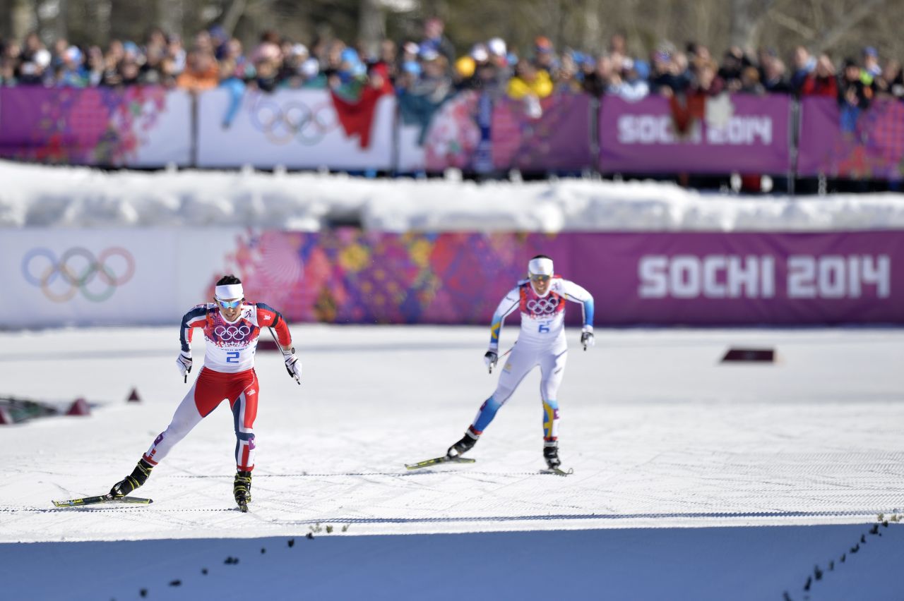Norway's Marit Bjoergen (left) skis her way to gold in  the women's skiathlon ahead of Charlotte Kalla of Sweden. 