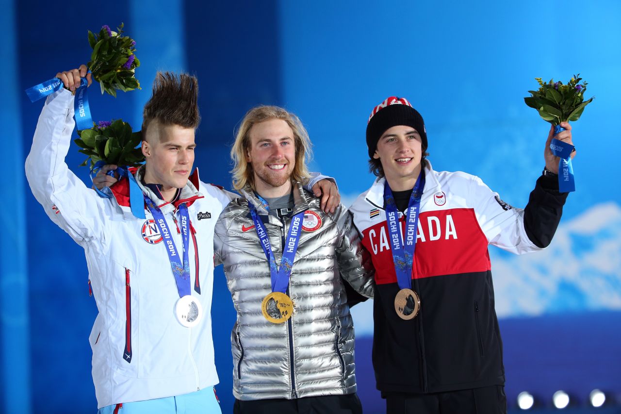 (From left to right) Silver medalist Staale Sandbech of Norway, gold medalist Sage Kotsenburg and bronze medalist Mark McMorris of Canada wave to the crowds from the podium following snowboard slopestyle medal ceremony.