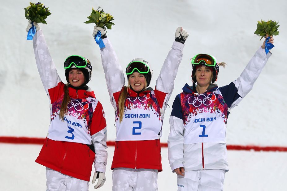 (From left to right) Silver medalist Chloe Dufour-Lapointe of Canada, gold medalist Justine Dufour-Lapointe of Canada and bronze medalist Hannah Kearney of the U.S. give a wave following the conclusion of the women's moguls event. 