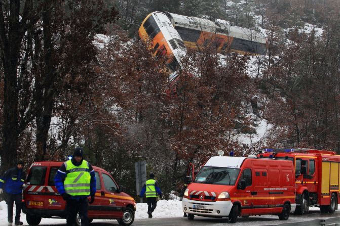Rescue workers work the scene of a train accident near Digne-les-Bains in the French Alps after a train derailed on February 8. The train collided with a large boulder, leaving two people dead and several others injured.
