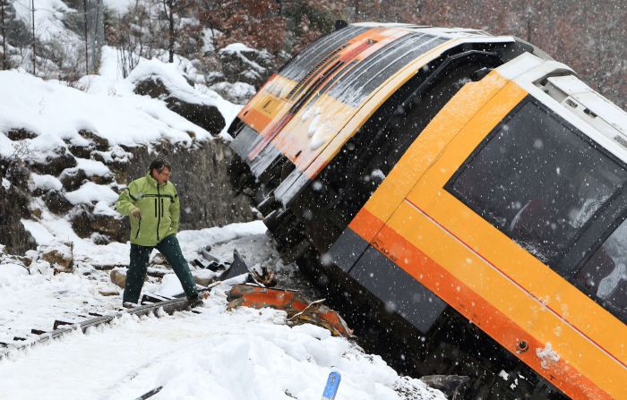 A man inspects the wreckage of the train. 
