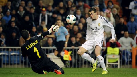 Gareth Bale dinks the ball over Villarreal keeper Sergio Asenjo to put Real Madrid ahead in the Bernabeu on Saturday.