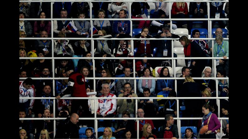 Fans watch the women's short program during team figure skating on February 8. 