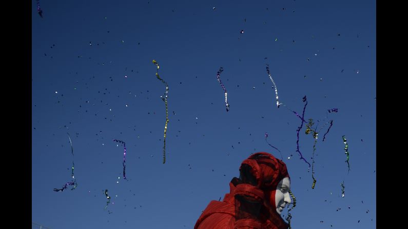 Streamers and confetti fly through the air as performers entertain fans February 8 at the Olympic village.