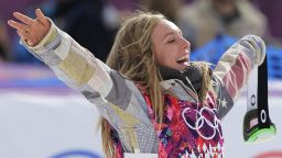 Jamie Anderson of the United States celebrates on the way to the flower ceremony after winning the women's snowboard slopestyle final at the 2014 Winter Olympics, Sunday, Feb. 9, 2014, in Krasnaya Polyana, Russia. (AP Photo/Andy Wong)
