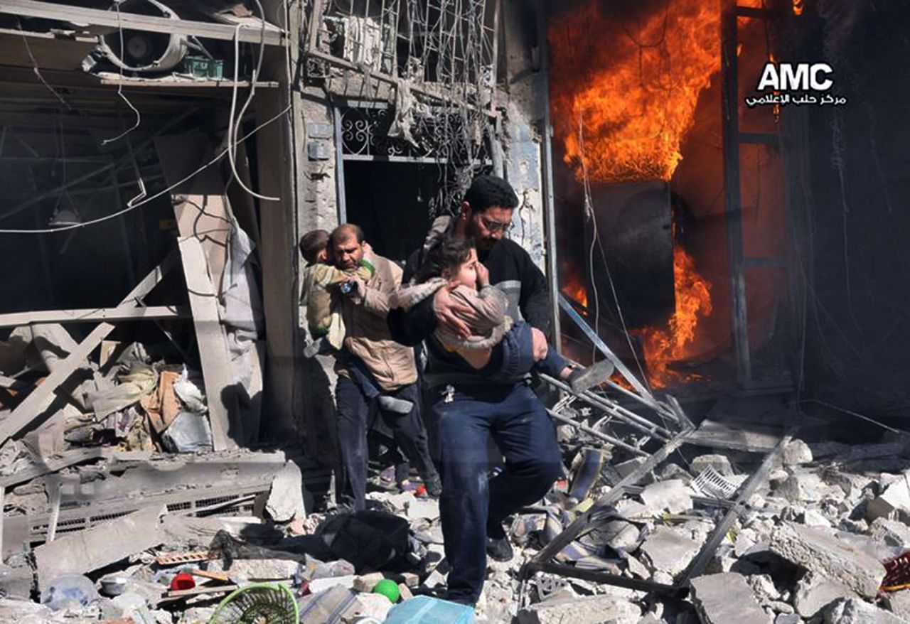 In this photo provided by the anti-government activist group Aleppo Media Center, Syrian men help survivors out of a building in Aleppo after it was bombed, allegedly by a Syrian regime warplane on Saturday, February 8.