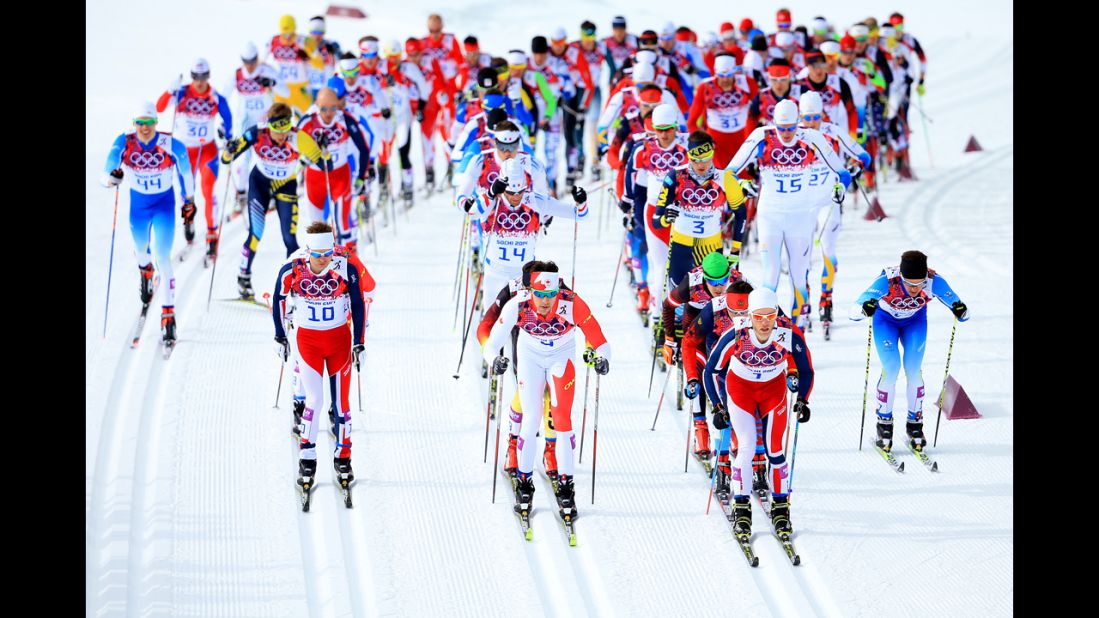 From left, Sjur Roethe of Norway, Alex Harvey of Canada and Martin Johnsrud Sundby of Norway lead the pack in the men's skiathlon event on February 9.