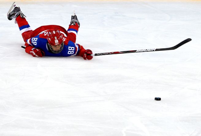 Yekaterina Smolina of Russia slides on the ice after being checked by Anja Weisser of Germany during their ice hockey game February 9.