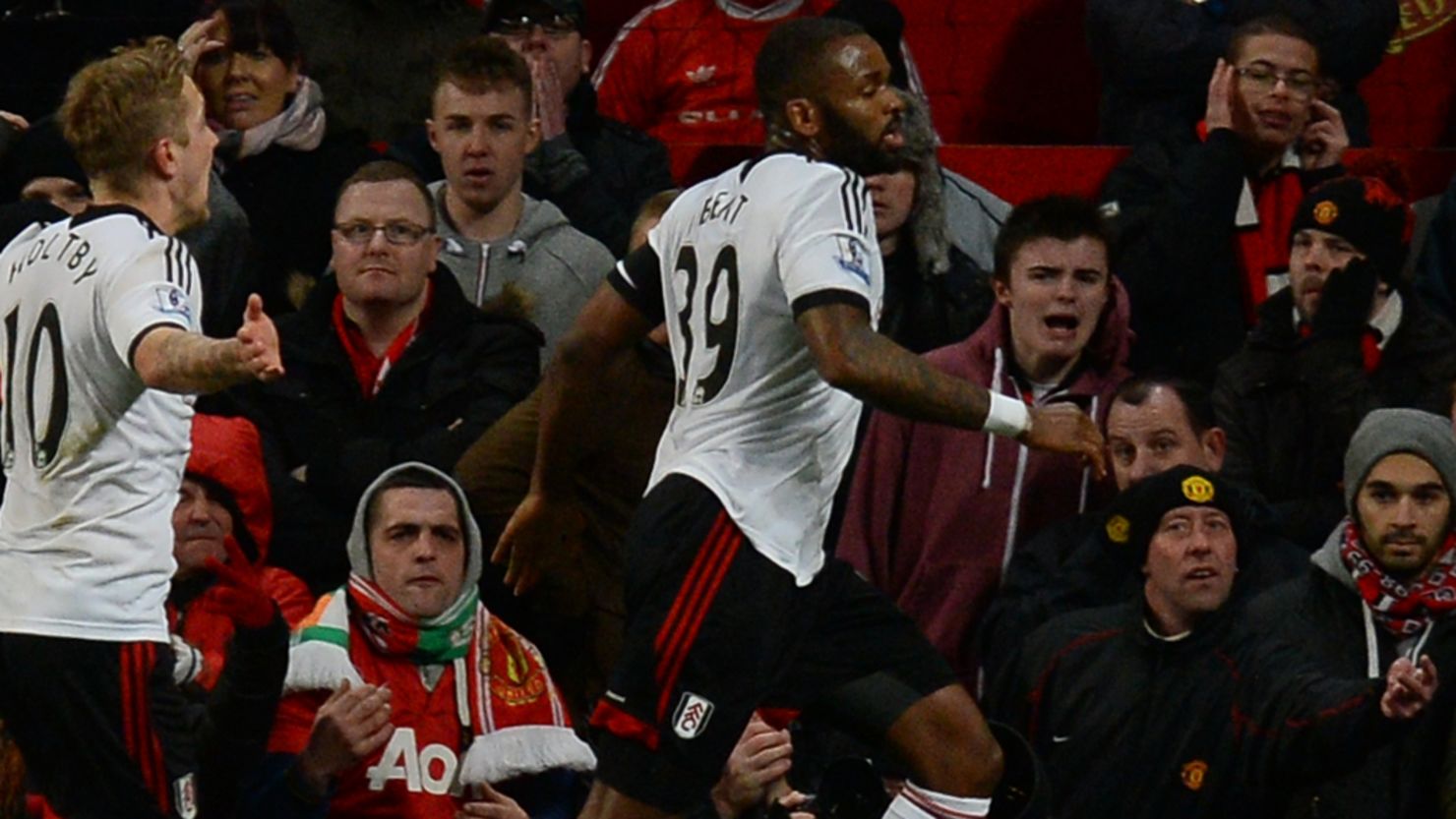 Darren Bent wheels away in triumph after scoring Fulham's injury-time equalizer against Manchester United at Old Trafford.