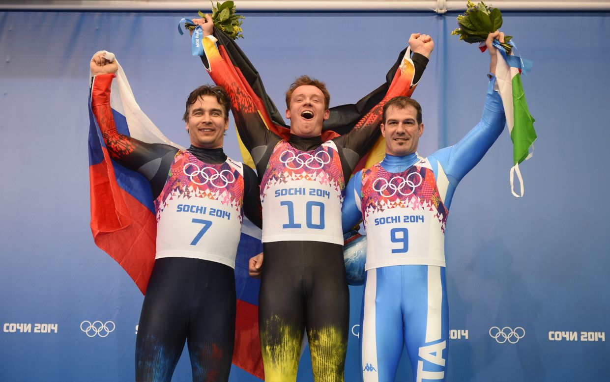 Germany's gold medal winner in the luge Felix Loch is flanked by Russia's silver medalist Albert Demchenko and Italy's Armin Zoeggeler, who took bronze.