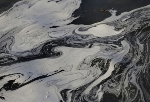 Coal ash swirls on the surface of the Dan River on Wednesday, February 5, as state and federal environmental officials continue their investigation of a spill of coal ash into the river near Danville, Virginia. Duke Energy estimated that up to 82,000 tons of ash had been released from a break in a 48-inch storm water pipe at the Dan River power plant in Eden, North Carolina. 