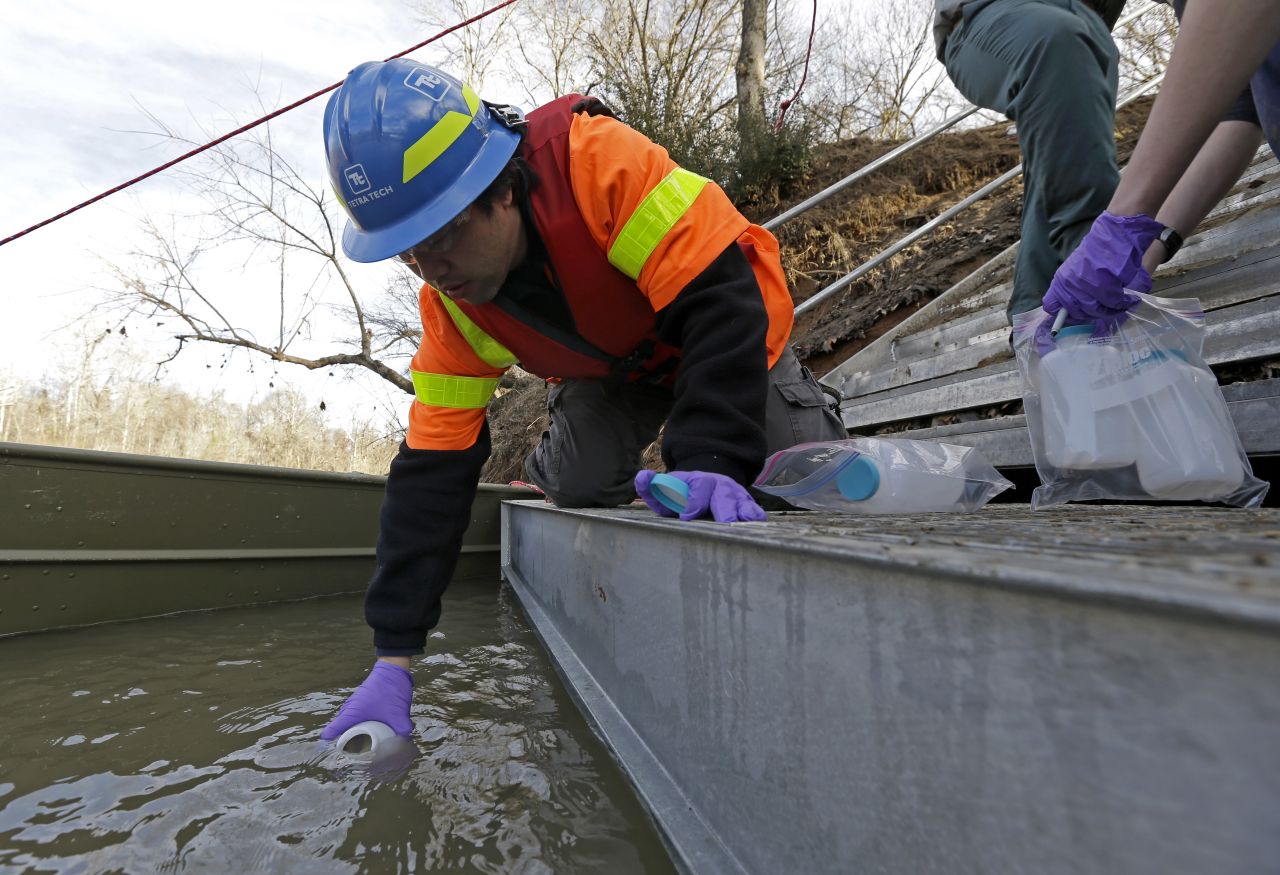 Didi Fung, a contractor for the Environmental Protection Agency, collects water samples from the Dan River on February 5. 