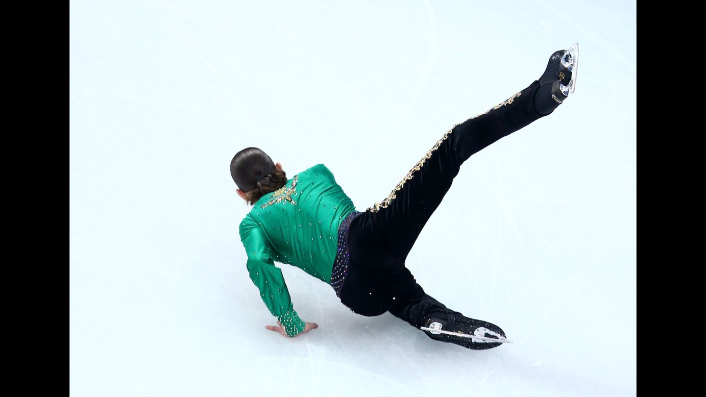Jason Brown of the United States falls February 9 while competing in the men's free skate portion of the team figure skating event.