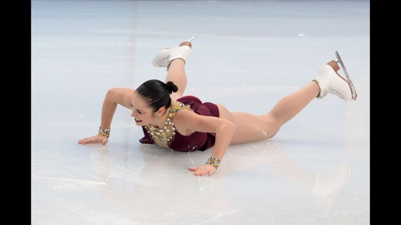 Canada's Kaetlyn Osmond falls as she performs in the women's free skate portion of the team figure skating event.