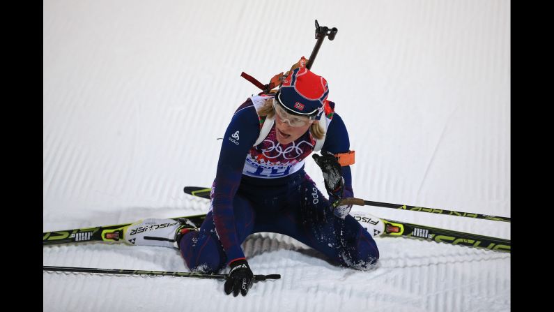 Biathlete Tora Berger of Norway collapses at the end of the women's 7.5-kilometer sprint.