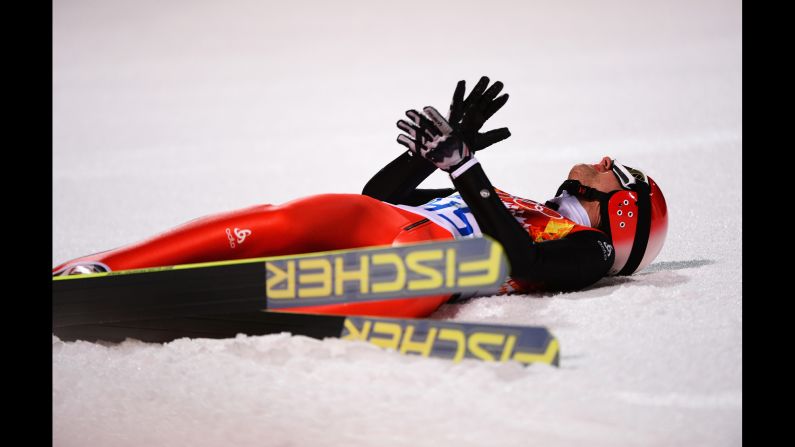 Simon Ammann of Switzerland reacts after landing his final jump in the men's normal hill ski jumping event February 9.