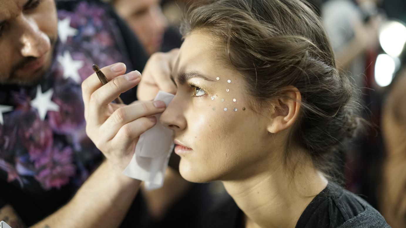Gemstones are applied to a model's eyes before the Lela Rose show on February 9.