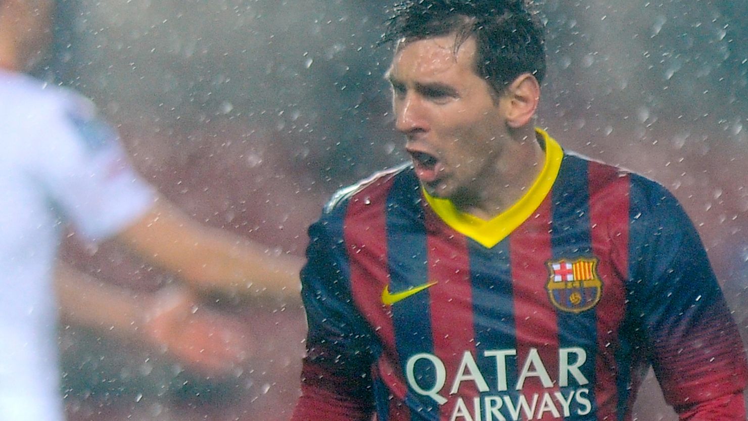 A soaked but happy Lionel Messi after scoring one of his two goals in Barcelona's 4-1 victory at Sevilla.